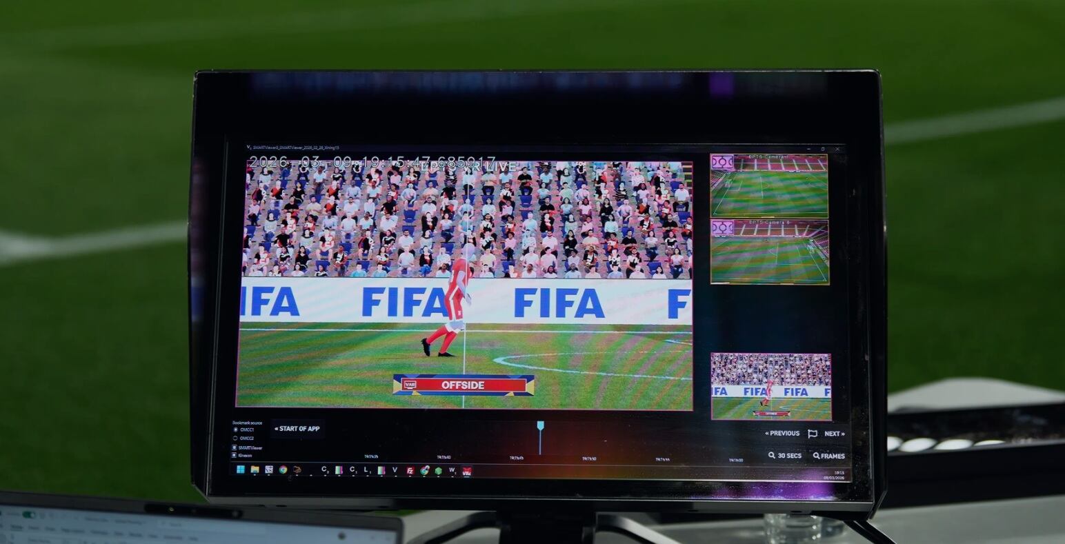 Broadcast monitor showing a FIFA video game scene with a player on a green field and an 'OFFSIDE' banner, crowd in the stands. The screen also includes inset angles on the right side.