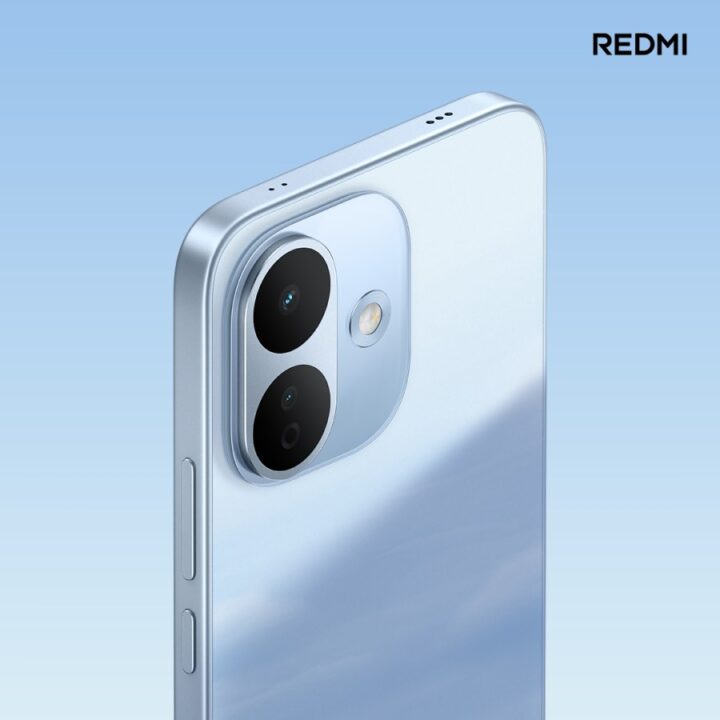 gsmarena_002 Back view of a blue Redmi smartphone with a triple-camera module and LED flash, against a blue gradient background (branding shows 'REDMI').